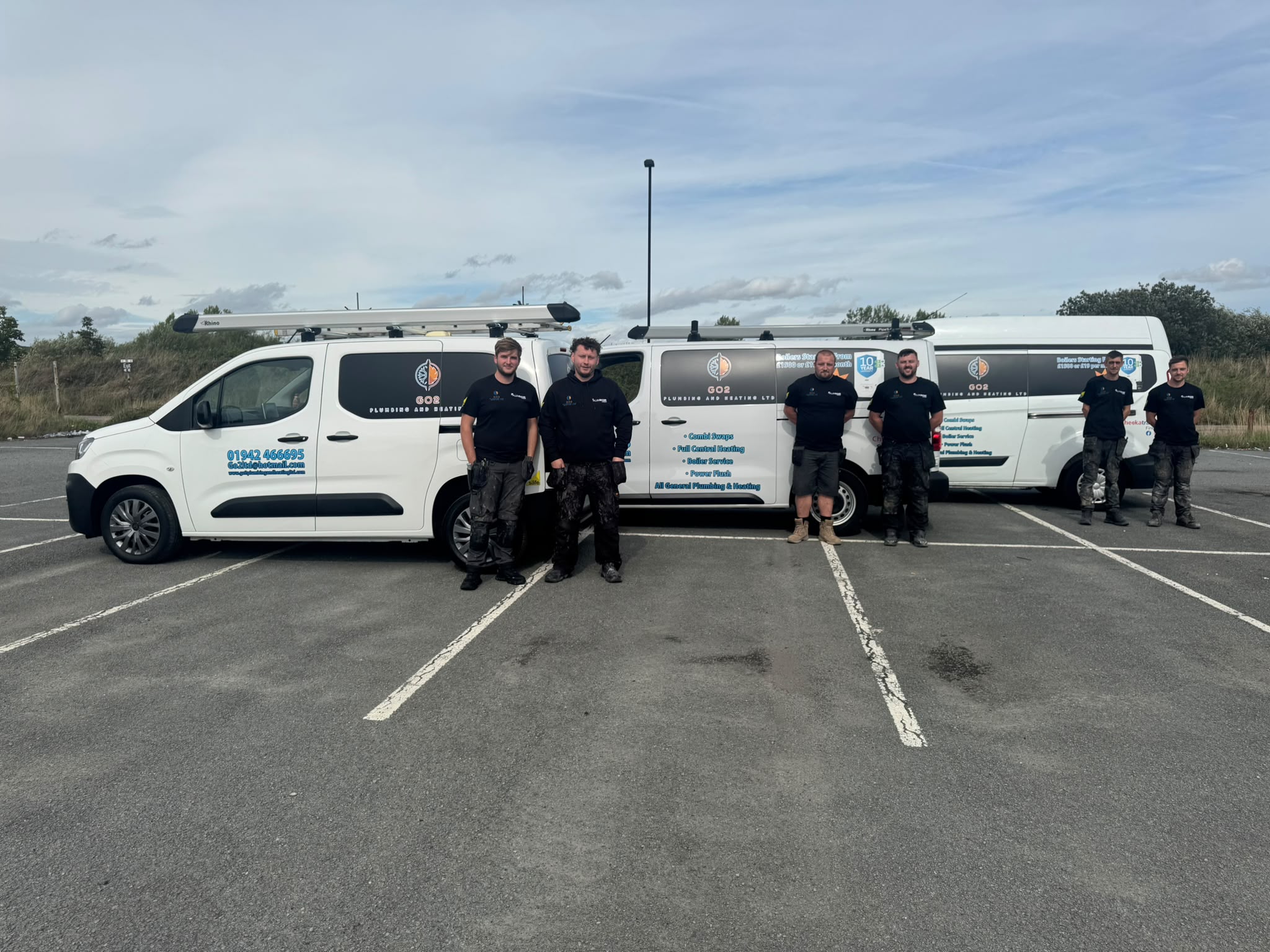 The GO2 Plumbing and Heating team with their branded vans