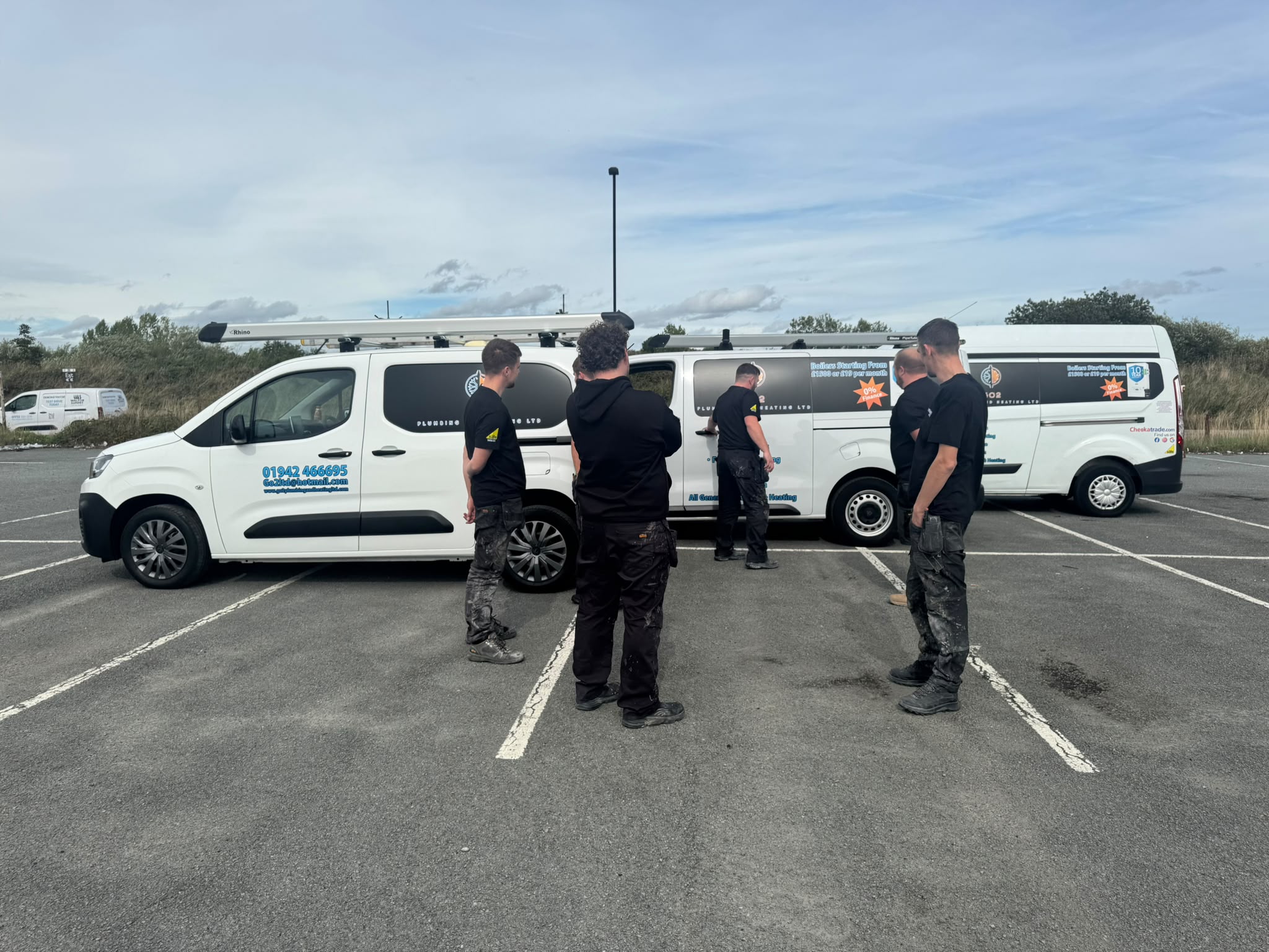 GO2 engineers gathered by the company vans