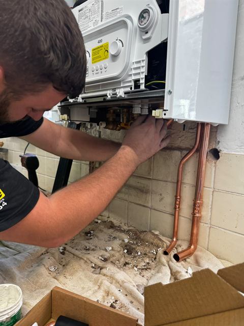 Gas Safe registered GO2 engineer fitting a new boiler in a Wigan home