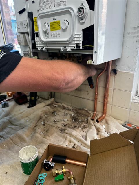 Gas Safe registered GO2 engineer fitting a new boiler in a Wigan home