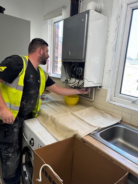 Gas Safe registered GO2 engineer fitting a new boiler in a Wigan home