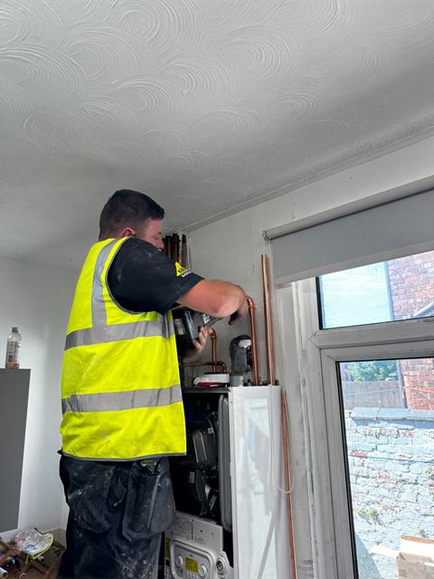 Gas Safe registered GO2 engineer fitting a new boiler in a Wigan home