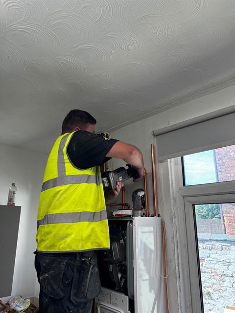 Gas Safe registered GO2 engineer fitting a new boiler in a Wigan home