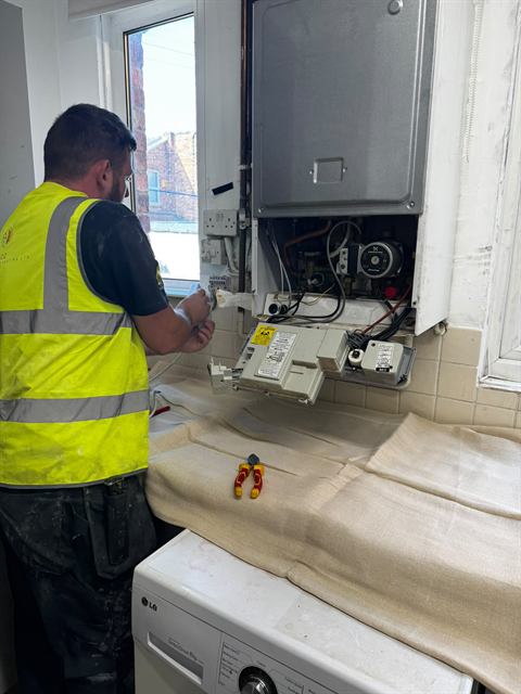 Gas Safe registered GO2 engineer fitting a new boiler in a Wigan home
